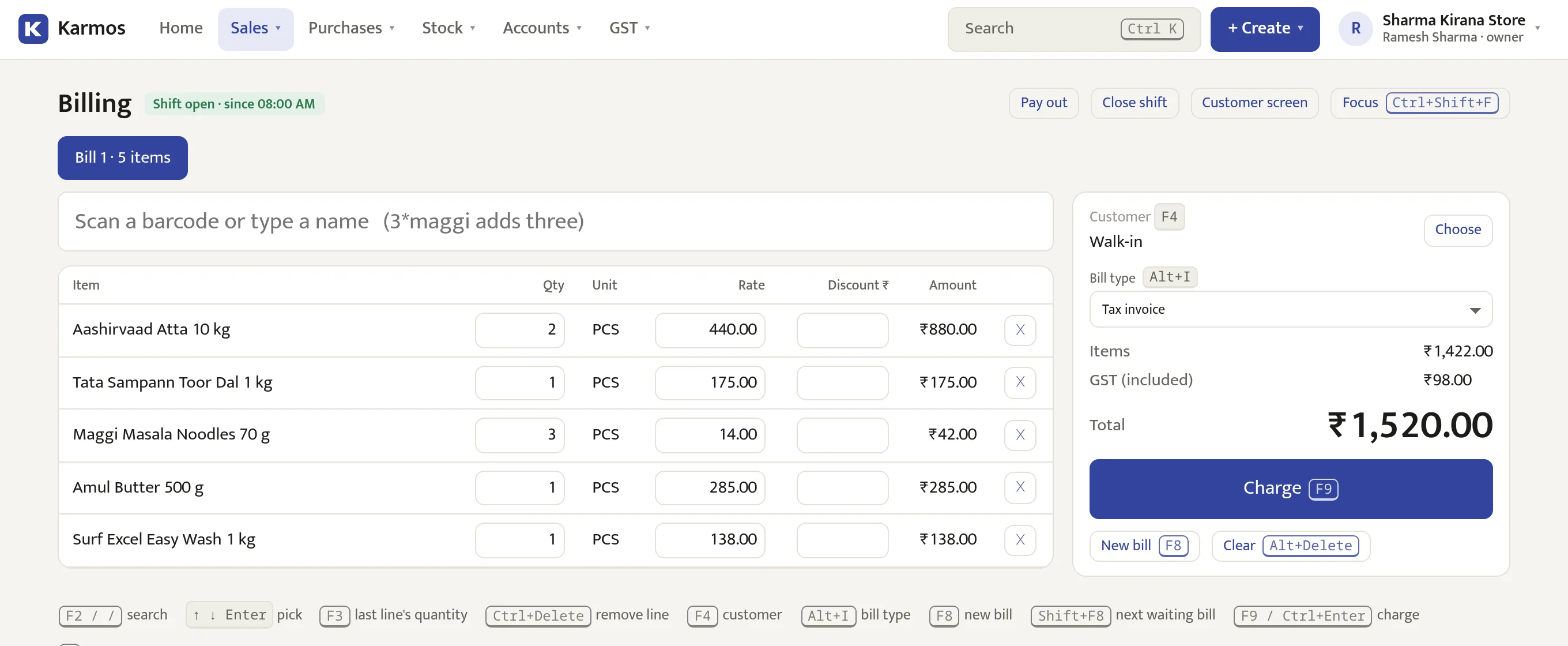 The Karmos counter on a computer: five items scanned, ₹1,520 total with GST included, and a Charge button